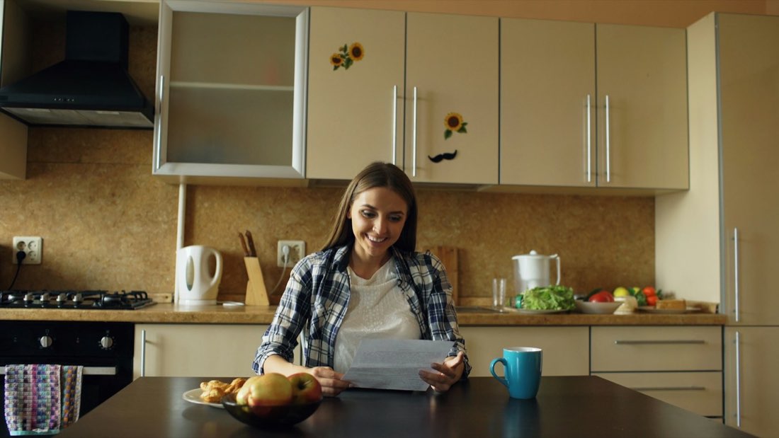 A homeowner reviewing written property sale options at a table